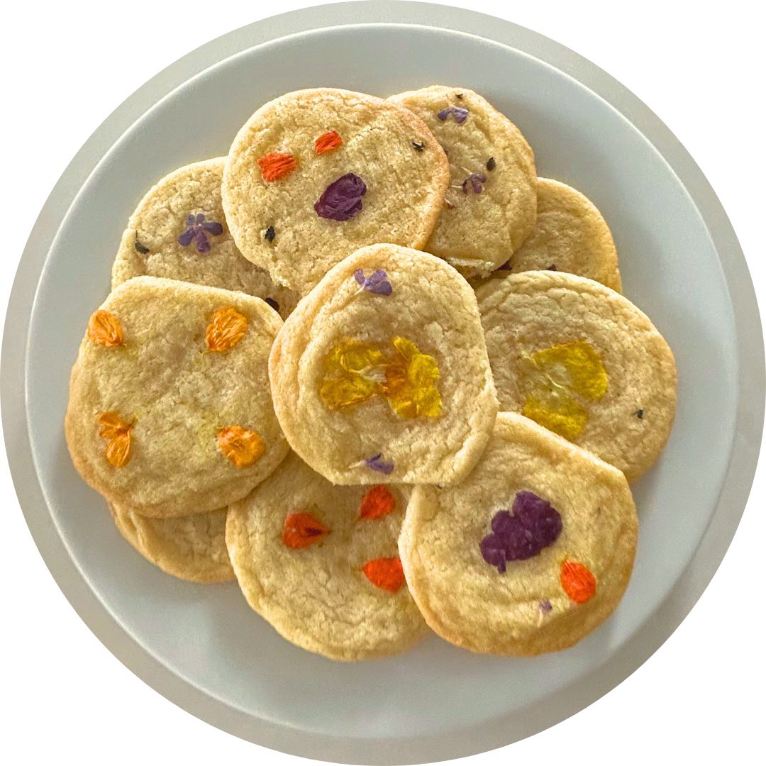 A plate of sugar cookies with edible flowers