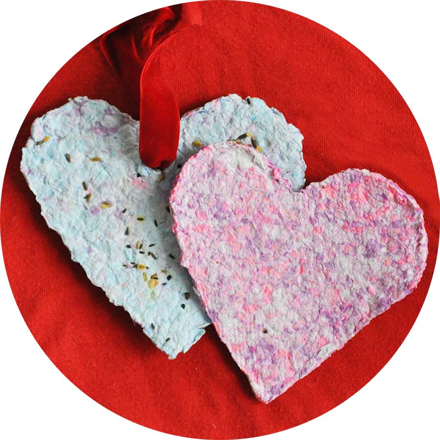 Paper heart valentines on red background