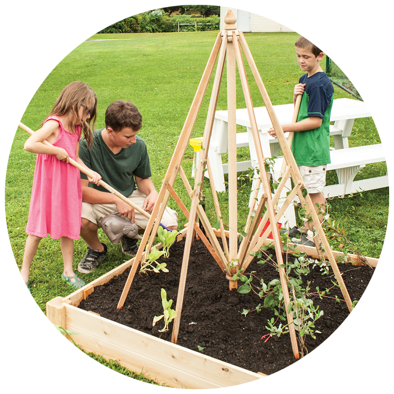 kids gardening in a raised bed